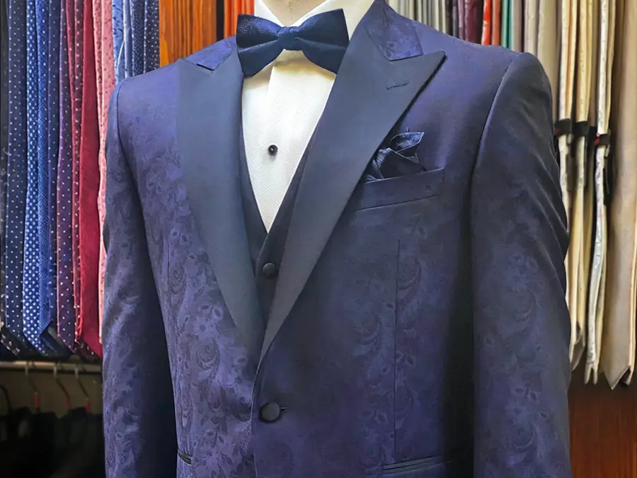A Paisley tone on tone pattern tuxedo with a peak lapel is a gorgeous fashion statement. This ensemble adds even more with a black vest. Bow ties and pocket squares complete the look and everything is available at Tom’s Place. tuxedo-in-paisley-vest